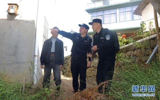 10月20日,庐镇派出所干警正在走访群众,协调解决邻里间土地纠纷。新华网发(王可海 摄)