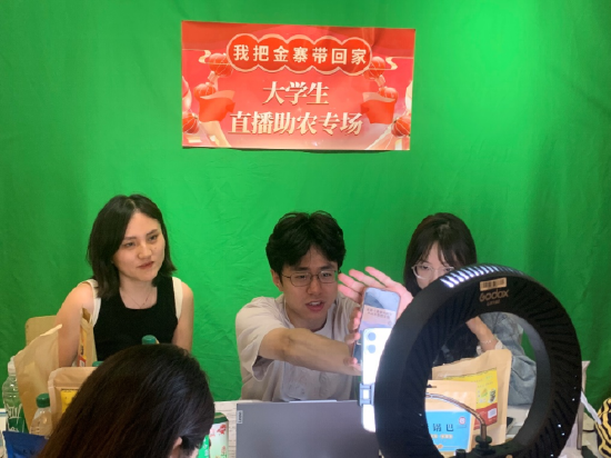 (商学院电子商务教师王雨鹤在屏幕外进行直播指导)