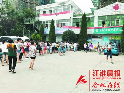 龙岗开发区社区卫生服务中心前,排队给孩子打疫苗的市民。