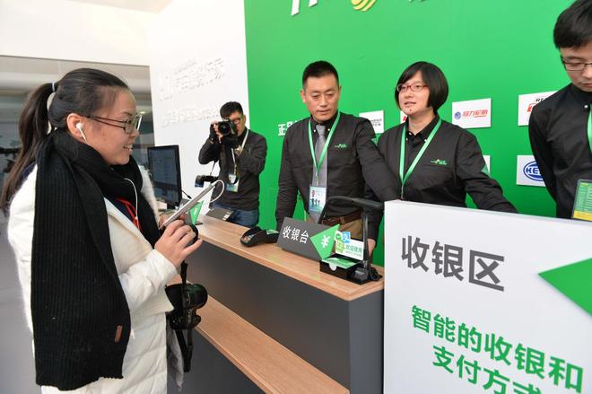 媒体记者在驰加2.0体验中心试用新门店收银台的支付新方式