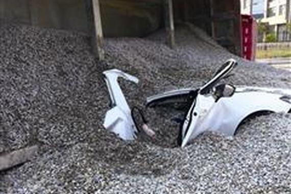 挂车侧翻50多吨石子倾斜被埋车内情侣身亡