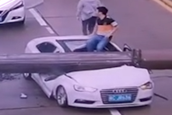 视频：轿车被吊臂砸扁司机自行爬出