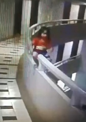 监控画面显示女孩试图翻越扶杆。(图源:《每日邮报》)