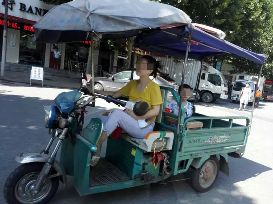 母亲边开三轮边喂奶