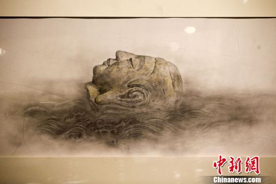 山西天龙山石窟流失海外佛像“重现故里”。 记者 张云 摄