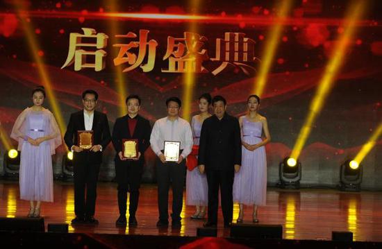 (怀仁市副市长王俊授予中国教育电视台频管中心主任李红根、作家网总编辑、诗意中国文学策划赵智、诗意中国总导演、主持人张宏“文化公益大使”)