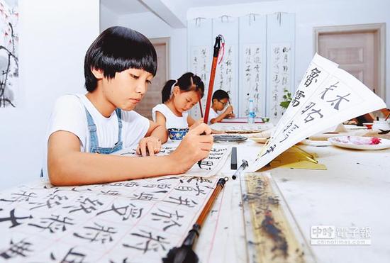 大陆教育部将书法纳入中小学课程，让学生临摹名家书法，体会古诗、文言文与汉字之美。（新华社提供）