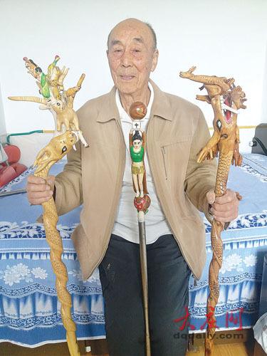 陈习淼老人和他亲手雕刻的中国龙手杖、和谐社会手杖、嫦娥探月手杖。