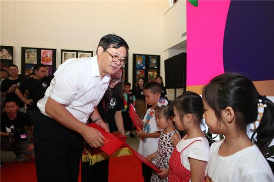 中国美协分党组书记、驻会副主席、秘书长徐里为孩子颁发证书