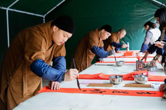 玉佛禅寺的法师们现场挥毫，奋笔疾书。