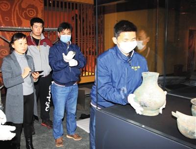 2月28日,首都博物馆,工作人员向首博汉氏展柜中布展青铜器。本版图片首都博物馆