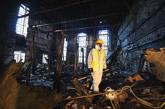 A forensic archaeologist in the Glasgow School of Art, following the disastrous fire. Jeff J Mitchell/Getty Images