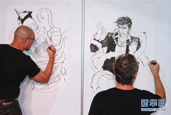 9月3日，在比利时布鲁塞尔，两名漫画家在漫画节现场作画。