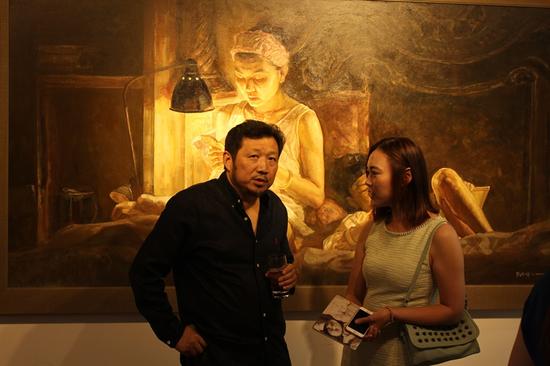 “温暖”2016刘亚明肖像作品展 现场 艺术家刘亚明（左）与嘉宾