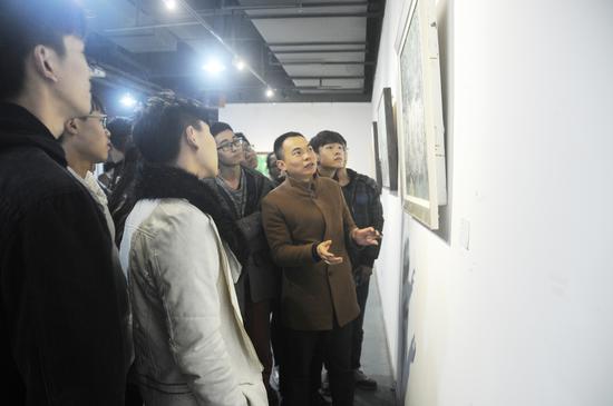 艺术家黄盛卫在展览现场为观众讲解作品