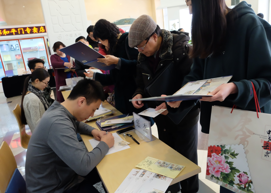 设计师为集邮爱好者签名