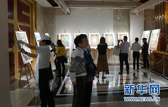 “五彩祥云——西藏唐卡艺术重庆首展”现场,吸引游客驻足流年。新华网发(主办方供图)