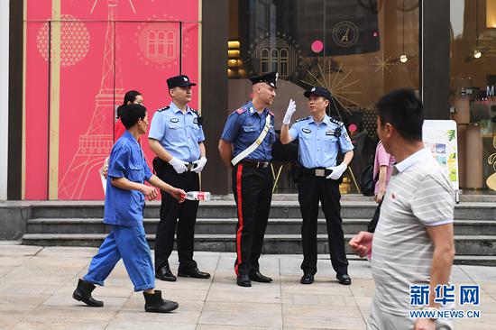 6月27日,中意警员在联合巡逻期间相互交流。新华网 李相博 摄