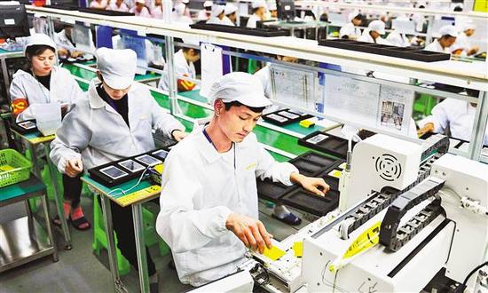 南岸区茶园新区一公司生产车间,工人正在生产手机.(本报资料照片)