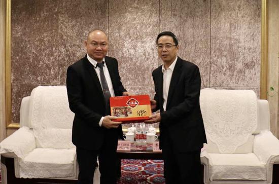 合川区委书记李应兰(右)向驻渝领事官员赠送合川特产。