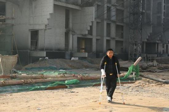河北定州胜利街建华社区的一个工棚内,重庆涪陵籍农民工赵家友拄着拐杖。
