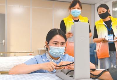 选手演示为老人测量血压。袁 兵摄(影像中国)