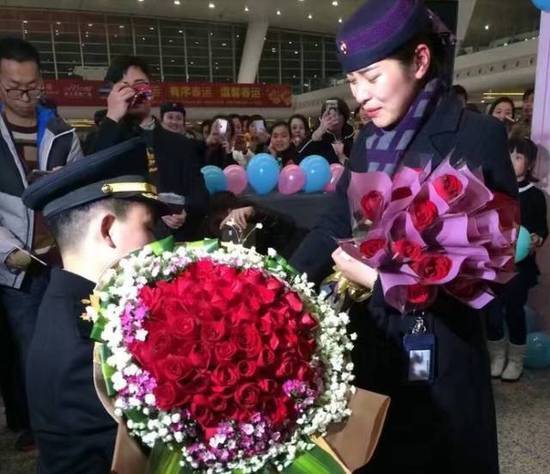 投影屏播放着王希昨夜熬夜制作的两人恋爱历程视频。大厅中响起了“嫁给他的、嫁给他的……”欢呼声。