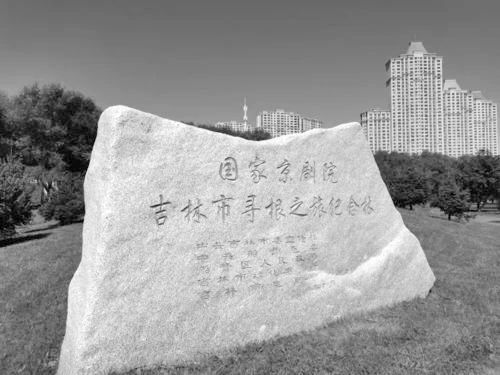 江湾大桥附近江畔绿地上竖立的“国家京剧院吉林市寻根之旅纪念林”碑石
