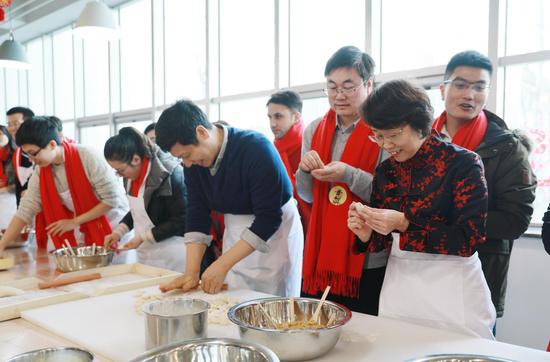 党委书记曹淑敏、校长徐惠彬和留校师生体验包饺子文化。北航宣传部供图