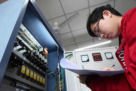 重庆，高职学生进行机床电气控制线路的故障排除比赛。视觉中国 资料