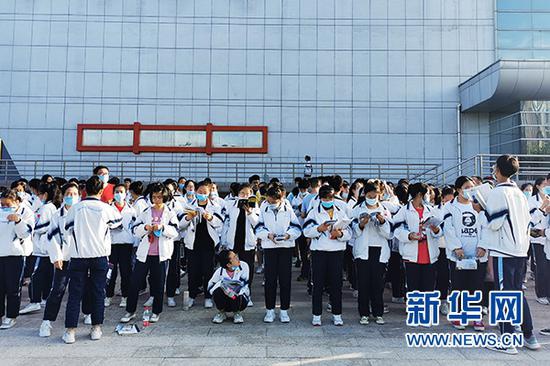 宁夏六盘山高级中学，文科9个班的400多名学生在等候送考车间隙背书。