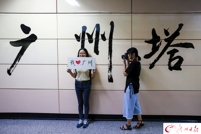 大学毕业生“怡宝”和摄影师在广州塔地铁站内拍摄别样毕业照