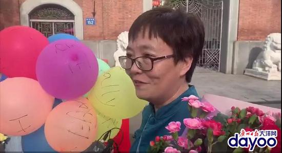 执信中学门口，一位妈妈手持一束气球和鲜花等待她的女儿。广报全媒体记者林亦旻