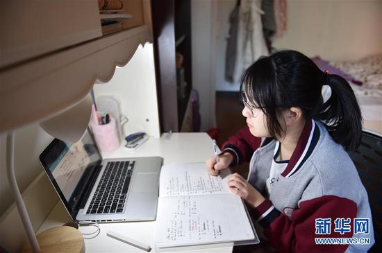 北京市第六十六中学初二年级学生黄雅慧在家中进行线上课程学习（陈钟昊 摄）