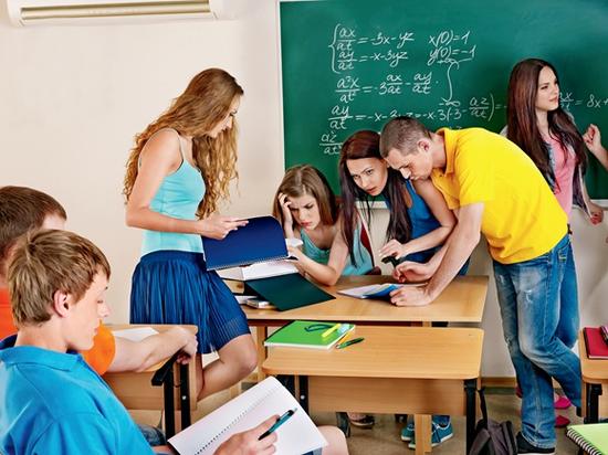 Group clever student near blackboard in classroom.