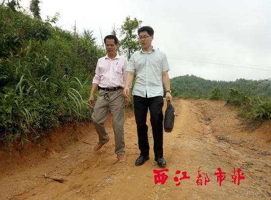 看着眼前的山路，马天宝（右）与村委主任高宝年商量，近期将邻村的村支书约在一起，共同商讨这条道路的修整工作。