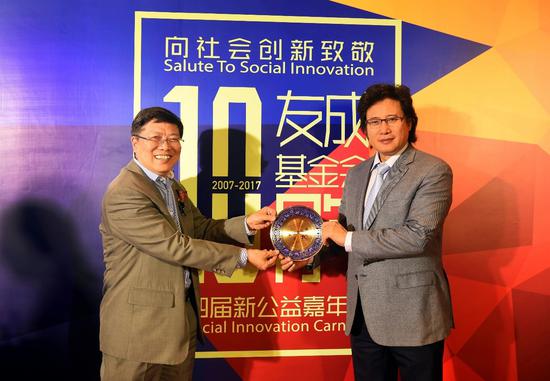 【图】国务院参事、友成基金会副理事长汤敏（左）向“戴你唱歌”超级声乐慕课项目创始人、国家著名歌唱家戴玉强（右）颁牌