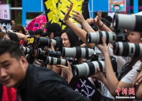粉丝们在北京一个粉丝嘉年华上拍摄偶像。中新社记者 刘关关 摄