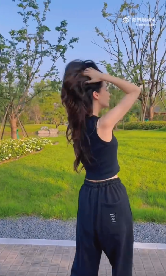Angelababy晒街边玩滑板视频 对镜头比耶笑容甜美