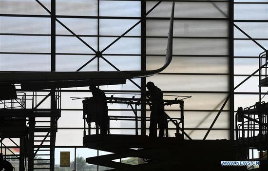 Members of staff work at Tianjin Haite Aircraft Engineering Co., Ltd. in Tianjin Pilot Free Trade Zone (FTZ), north China's Tianjin, Sept. 17, 2020. With a number of high-end aviation maintenance enterprises gathering in the FTZ in Tianjin, the area has become an advanced aviation maintenance and testing base in the Asia-Pacific region. (Photo by Zhao Zishuo/Xinhua)