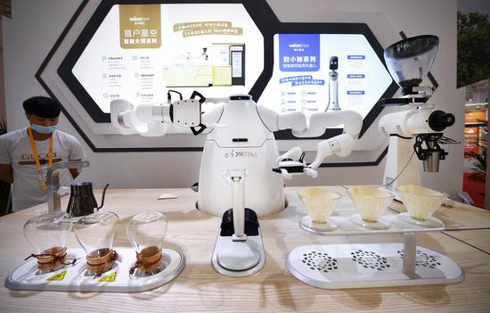 Photo taken on May 9, 2021 shows a domestically produced coffee robot on display during the first China International Consumer Products Expo in Haikou, capital of south China's Hainan Province. (Xinhua/Guo Cheng)