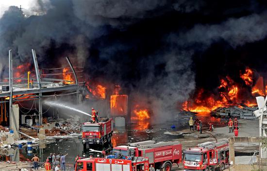 Lebanese firefighters try to put out a fire that broke out at Beirut's port area on September 10, 2020.