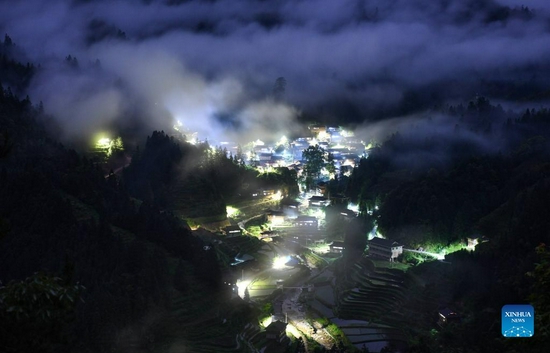 Photo taken on May 20, 2021 shows the night view of Dangjiu Village in Gandong Township of Rongshui Miao Autonomous County, south China's Guangxi Zhuang Autonomous Region. More and more solar powered street lamps have been erected in areas tucked away in the mountains in Guangxi, illuminating the night sky for people living there. (Xinhua/Huang Xiaobang) 