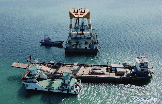 A crane works to lift the wreckage of the Dingyuan Battleship out of seawater near Liugong Island in the city of Weihai, east China's Shandong Province, Sept. 18, 2020. (national center of the underwater cultural heritage of the National Cultural Heritage Administration/Handout via Xinhua)