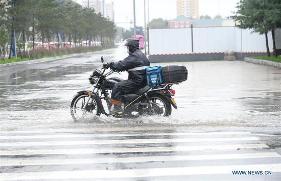 A food deliveryman rides a motorcycle amid rain triggered by Typhoon Haishen in Changchun, northeast China's Jilin Province, Sept. 8, 2020. Heavy rain hit most parts of the city of Changchun from Monday night to Tuesday fueled by Typhoon Haishen, the 10th typhoon this year. China's State Flood Control and Drought Relief Headquarters on Monday upgraded its emergency response for flood and typhoon control from Level IV to Level III, as Typhoon Haishen-triggered downpours are expected in vast stretches of northeast China over the next two days. (Photo by Yan Linyun/Xinhua)