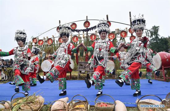 People in traditional costumes dance for bumper harvest at Dangzao Village of Panshi Town in Tongren City, southwest China's Guizhou Province, Sept. 20, 2020. Various activities are being held across the country to welcome the third Chinese farmers' harvest festival which falls on Sept. 22. (Photo by Long Yuanbin/Xinhua)