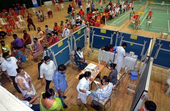 People line up for the COVID-19 vaccine at a stadium in Guwahati, India, April 22, 2021. (Str/Xinhua)