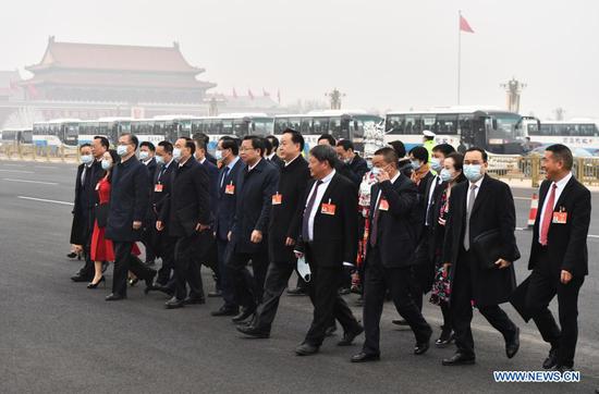 Deputies to the 13th National People's Congress (NPC) walk towards the Great Hall of the People for the opening meeting of the fourth session of the 13th NPC in Beijing, capital of China, March 5, 2021. (Xinhua/He Changshan)