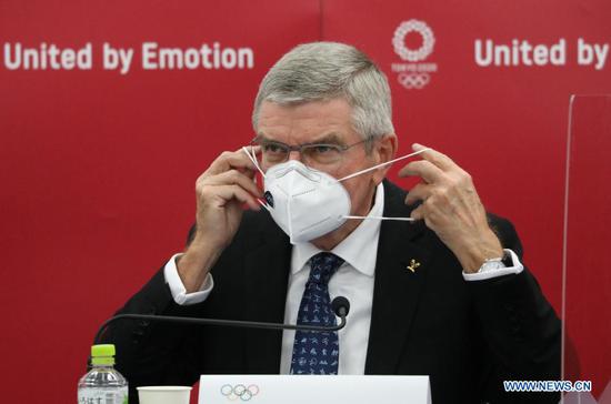 International Olympic Committee (IOC) president Thomas Bach puts his face mask on after a joint press conference between IOC president and Tokyo 2020 president Mori Yoshiro in Tokyo, Japan, Nov. 16, 2020. (Xinhua/Du Xiaoyi)