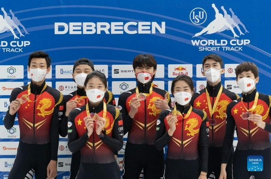 Members of Team China celebrate during the awarding ceremony after the Mixed 2000 m Relay Final during the ISU World Cup Short Track Speed Skating series in Debrecen, Hungary on Nov. 21, 2021. (Photo by Attila Volgyi/Xinhua)
